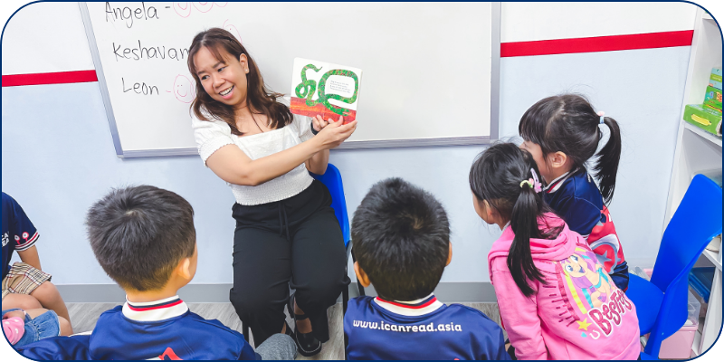 Teacher reading a book to students in an I Can Read class