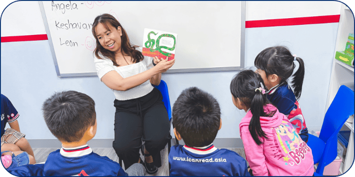 Teacher reading a book to students in an I Can Read class