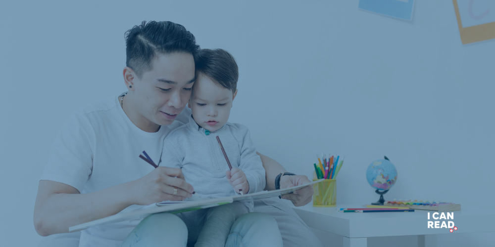 A child is practising writing with his father.