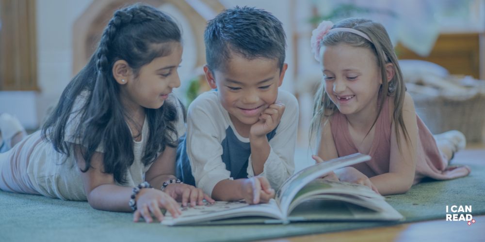 3 young children reading a book