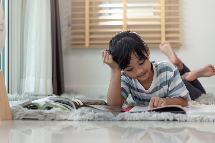 child-reading-book-at-home