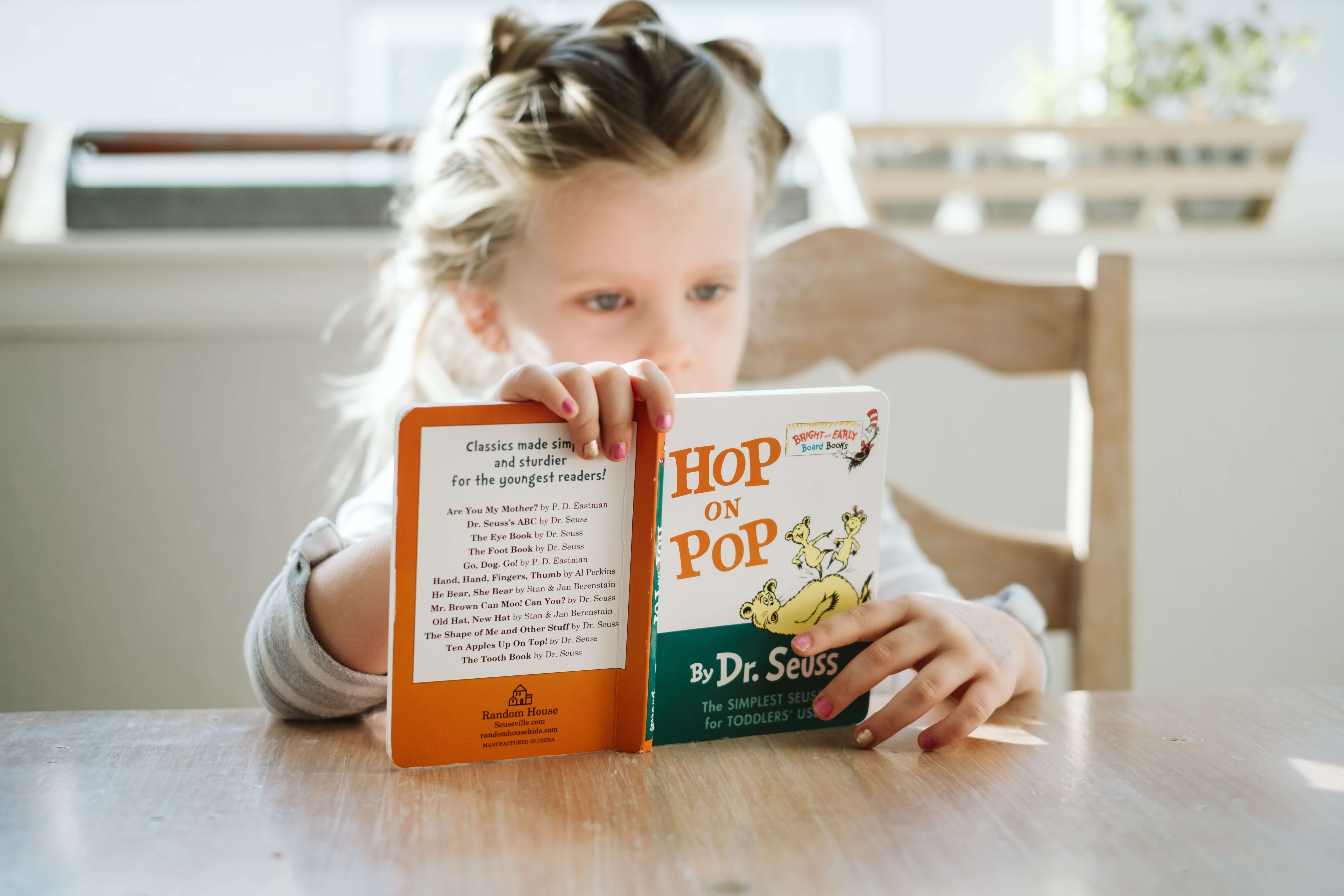 Child holding and reading an English book