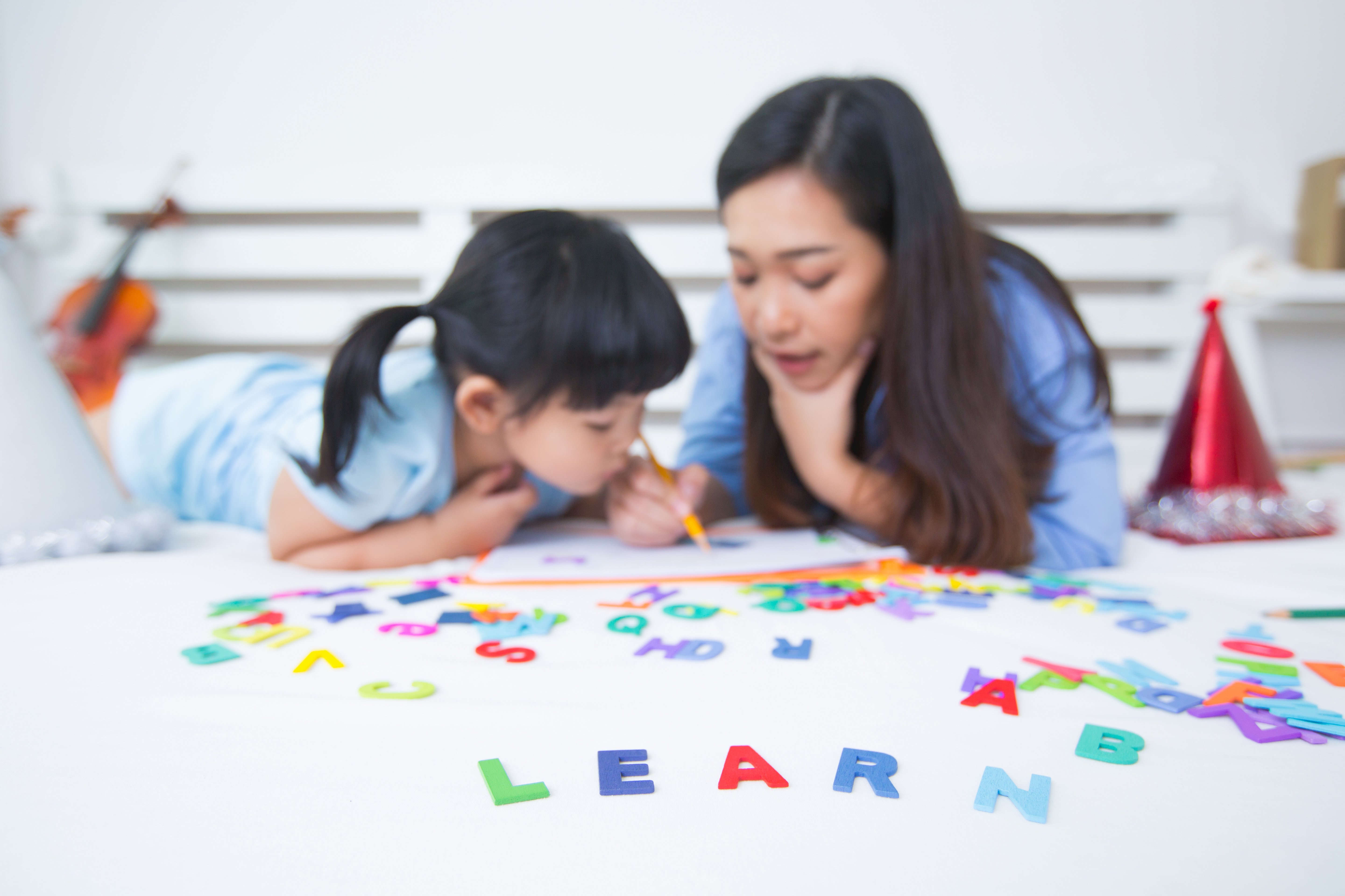 mother-daughter-studying-alphabet