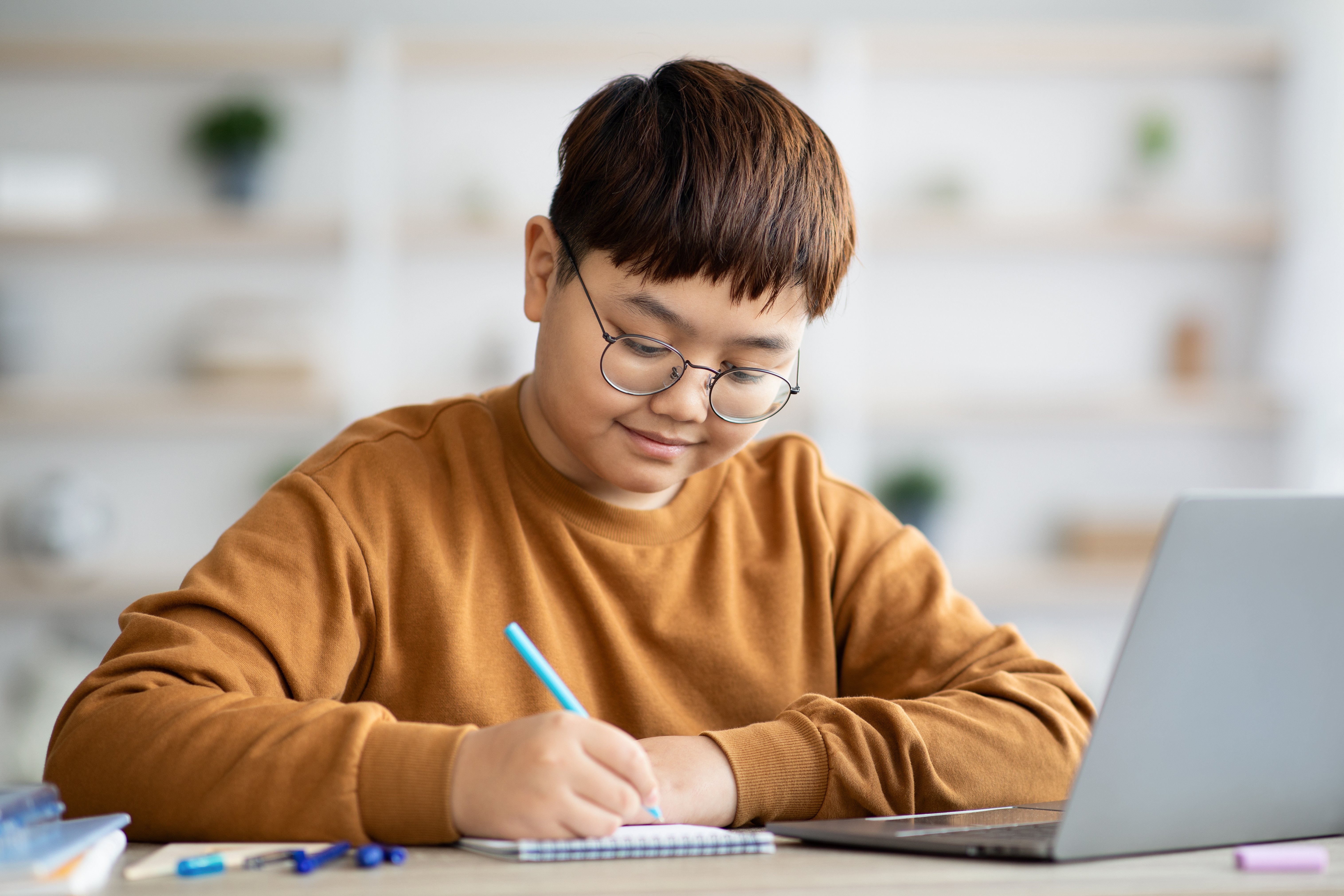 plump-chinese-boy-nerd-doing-homework-using-lapto-2023-11-27-05-15-15-utc